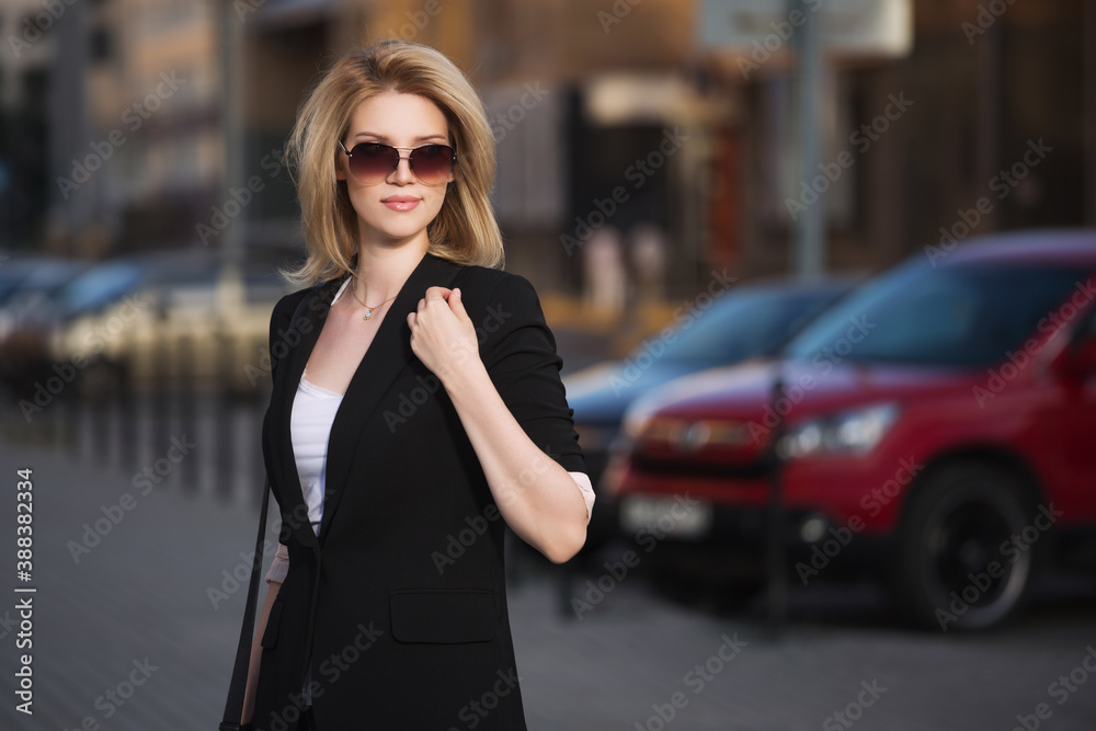 Young fashion blond business woman in black blazer and sunglasses Young fashion blond business woman in black blazer and sunglasses