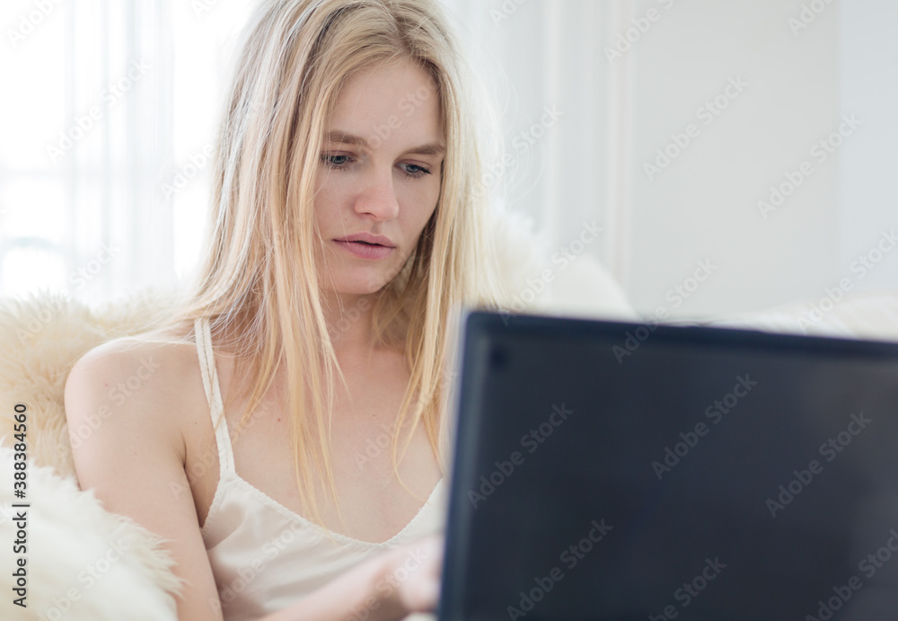 Beautiful woman using a laptop computer working from home. Beautiful woman using a laptop computer working from home.