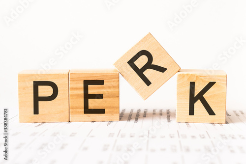 Word perk. Wooden small cubes with letters isolated on white background with copy space available.Business Concept image.