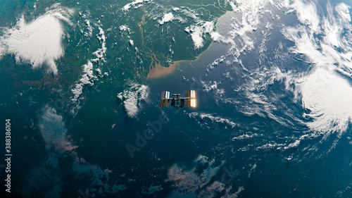 Fototapeta Naklejka Na Ścianę i Meble -  International Space Station (ISS) Orbiting Earth over Amazon River in Space Top Down View - SpaceX & NASA Research - ISS Satellite Ocean Sunset View Low Orbit - 3D Rendering	