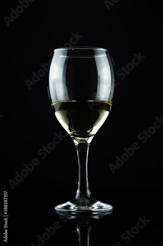 wine bottle and glass, black background 