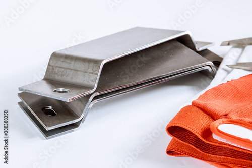 Product for metal bending, gloves, caliper on a white background
