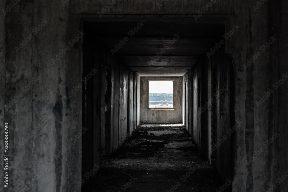 Dark cold weathered abandoned floor way with lighted picture like window in the end. From darkness to new beginning