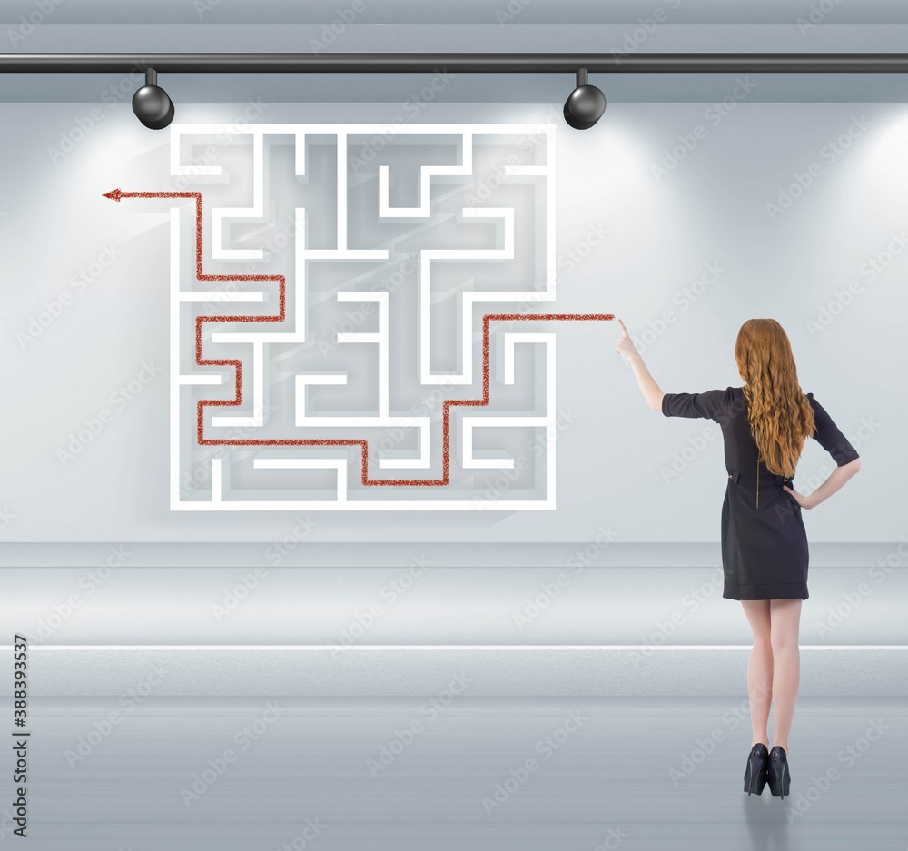 Businesswoman is looking for ways to escape from maze labyrinth Businesswoman is looking for ways to escape from maze labyrinth