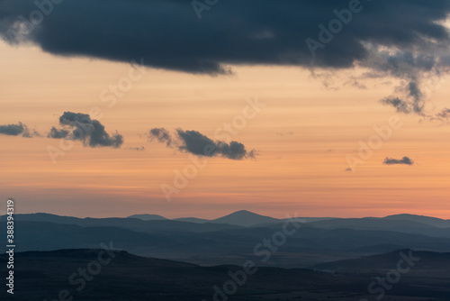 Fototapeta Naklejka Na Ścianę i Meble -  Landscape sunset colors over mountains and hills orange red yellow blue shades natural beauty bulgaria rural