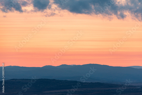 Fototapeta Naklejka Na Ścianę i Meble -  Landscape sunset colors over mountains and hills orange red yellow blue shades natural beauty bulgaria rural