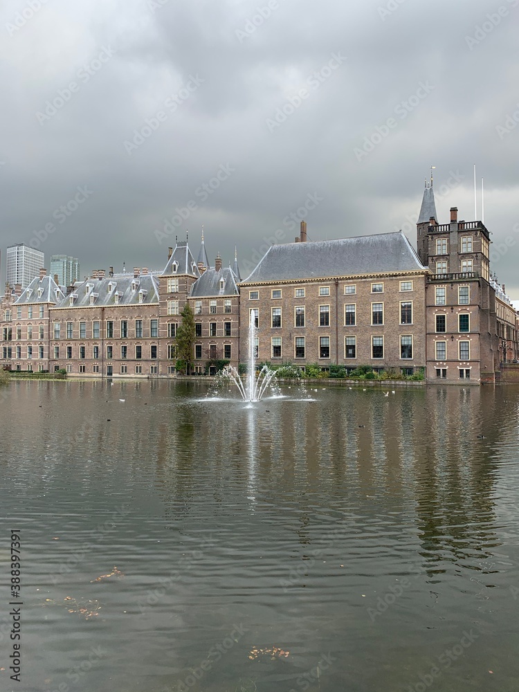 The Hague's Binnenhof with the Hofvijver. Dutch Senate and House of Representatives (Parliament) building with running fountain in the pond at the front. Den Haag / Netherlands.