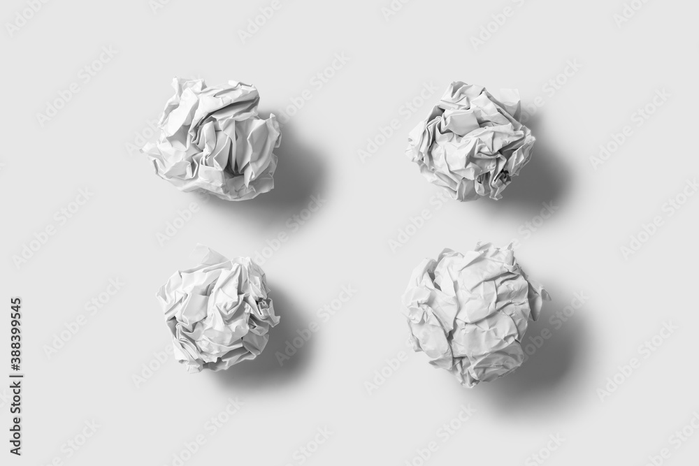 White crumpled paper balls isolated on light grey background. High resolution. White crumpled paper balls isolated on light grey background. High resolution.