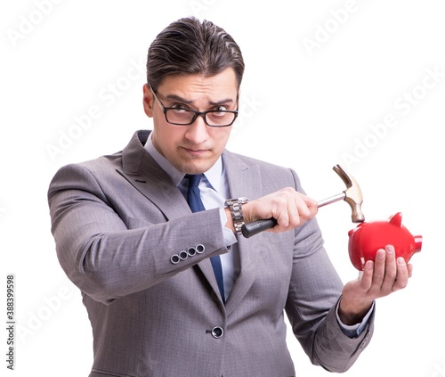 Businessman breaking piggybank isolated white background