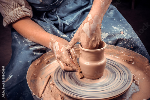 Young female potter working on a potter's wheel