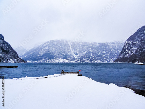 Jetty in a winter landscape at the fjord lake, Norway. photo