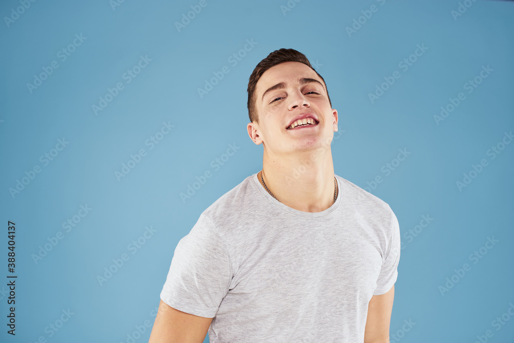 Emotional man in white t-shirt cropped view on blue background lifestyle Emotional man in white t-shirt cropped view on blue background lifestyle