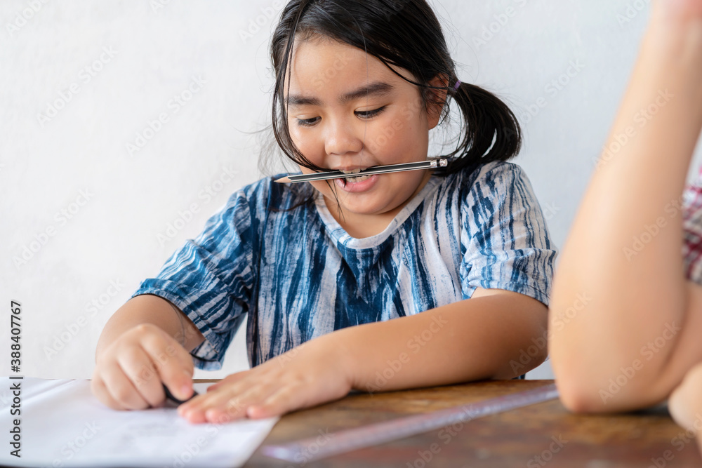 A cute Asian female student studying closely with her teacher, she is erasing the wrong training, education concept. A cute Asian female student studying closely with her teacher, she is erasing the wrong training, education concept.