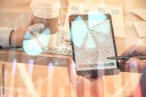 Double exposure of man's hands holding and using a phone and financial chart drawing. Market analysis concept.