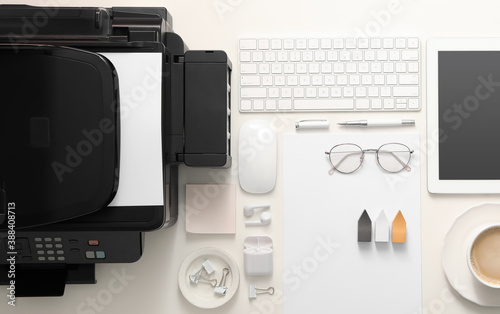 New modern printer, tablet and office supplies on white table, flat lay