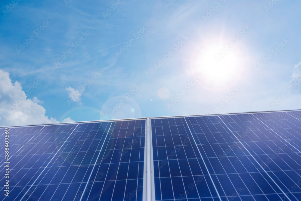 Solar panel, photovoltaic, alternative electricity source - concept of sustainable resources. blue sky background with white clouds, the sun shines in a starry sky