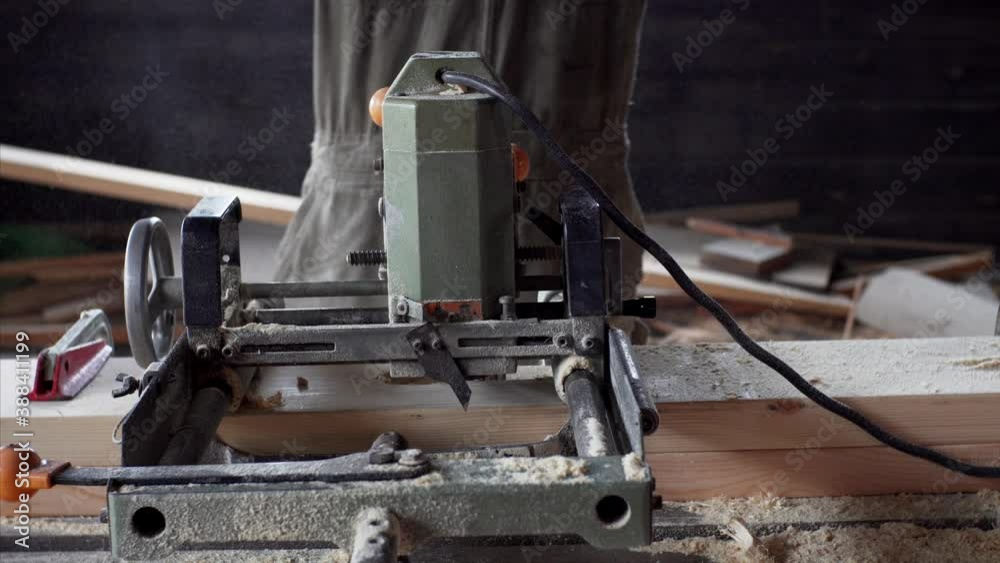 Sliding view of the CNS machine.Carpenter cleans himself from sawdust after work Sliding view of the CNS machine.Carpenter cleans himself from sawdust after work