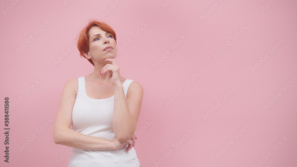 Beautiful redhead woman in white sweatshirt isolated on pink background. Thinking and brainstorming concept. High quality photo Beautiful redhead woman in white sweatshirt isolated on pink background. Thinking and brainstorming concept. High quality photo