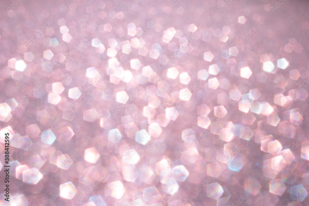 Defocused abstract pink twinkle light background. Pink glittery bright shimmering background use as a design backdrop. Defocused abstract pink twinkle light background. Pink glittery bright shimmering background use as a design backdrop.