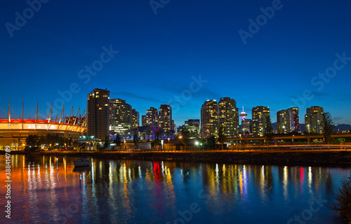 Vancouver city skyline at night, Brithish Columbia, Canada. Colorful reflections of city buildinsg in False Creek. © avmedved