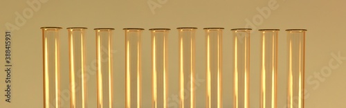 A row of glass empty gold test tubes with necks. In the warm.