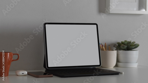 Workspace with nock up blank screen tablet with office supplies, clipping path © bongkarn