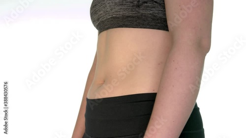 Side view of a woman's belly. The woman moves her stomach muscles because of the laughter. Seeing how the diaphragm works while inhaling and exhaling. Confulative breathing. Human body work anatomy.