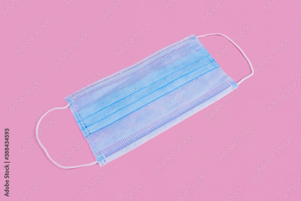 Medical mask on a pink background. mask that protects against viruses. Covers the mouth and nose to protect against viruses and bacteria on a pink background. The concept of an epidemic. Medical mask on a pink background. mask that protects against viruses. Covers the mouth and nose to protect against viruses and bacteria on a pink background. The concept of an epidemic.