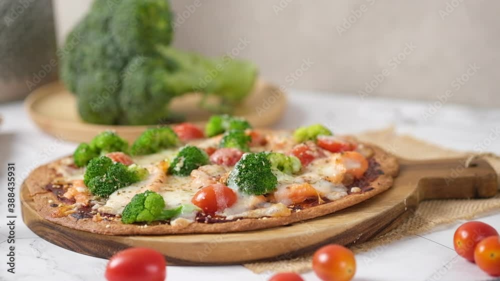 Cheesy Keto Pizza with Tomatoes Broccoli And Salmon for ketogenic diet. set on white cafe table. Cheesy Keto Pizza with Tomatoes Broccoli And Salmon for ketogenic diet. set on white cafe table.