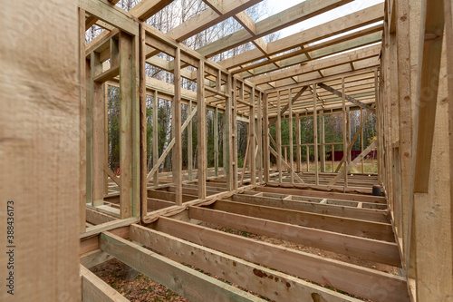 Construction of a frame house in the forest. Autumn