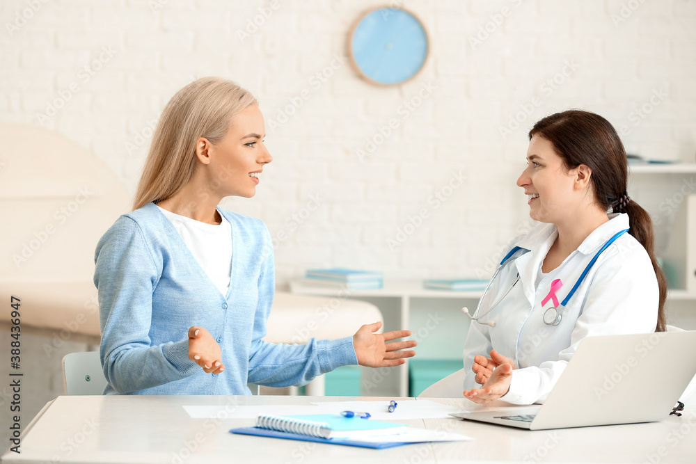 Young woman visiting doctor in clinic. Breast cancer awareness Young woman visiting doctor in clinic. Breast cancer awareness