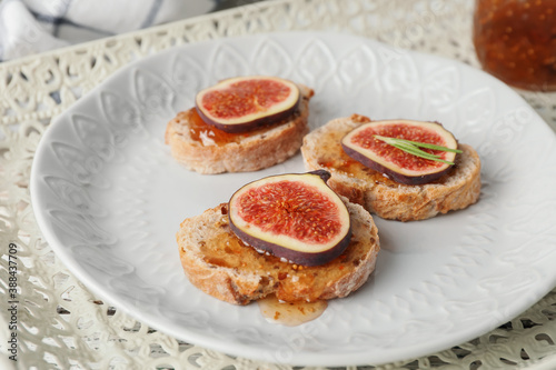Tasty sandwiches with fig jam on plate