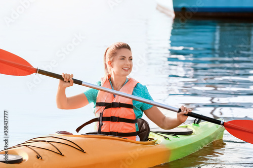 Young woman kayaking in river