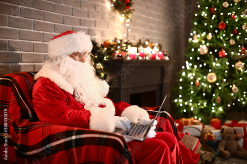 Santa Claus with laptop at ...