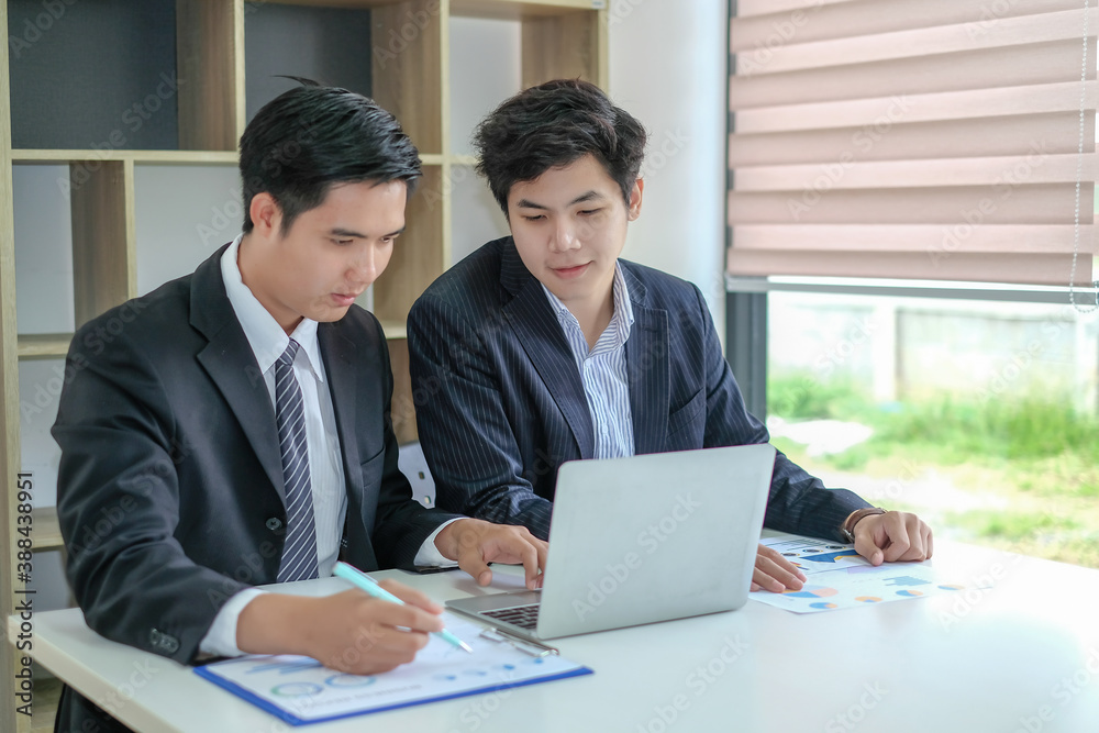 Two young asian businessman working together at office modern. Two young asian businessman working together at office modern.
