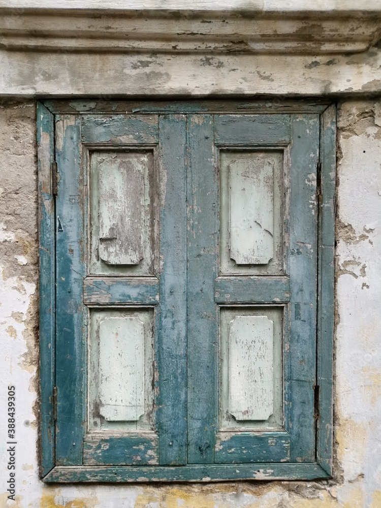 Weathered wooden windows on concrete wall Weathered wooden windows on concrete wall