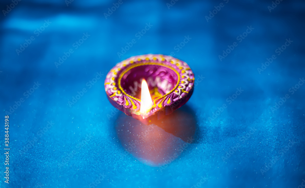 Beautiful clay diya lamps lit during diwali celebration, selective focus Beautiful clay diya lamps lit during diwali celebration, selective focus