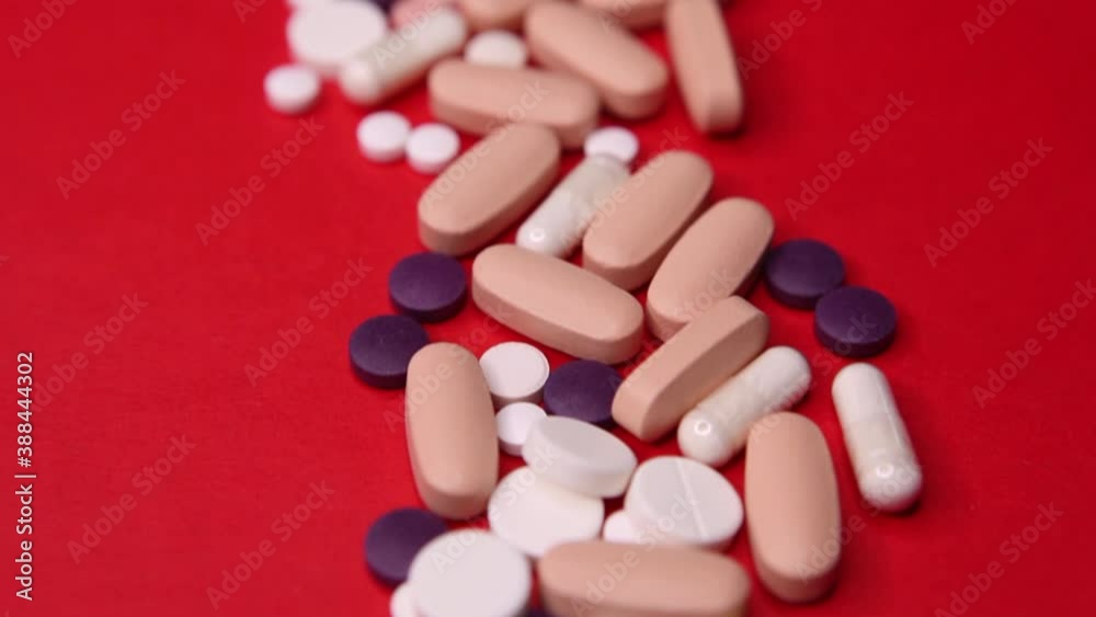 Various pills macro on red background. Top view Various pills macro on red background. Top view