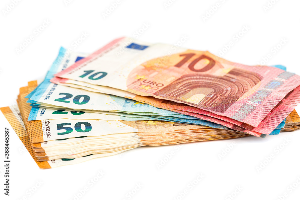 various denominations of euro banknotes on white. Place for text.