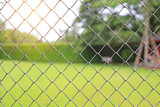 metal grille fence and defocused nature background