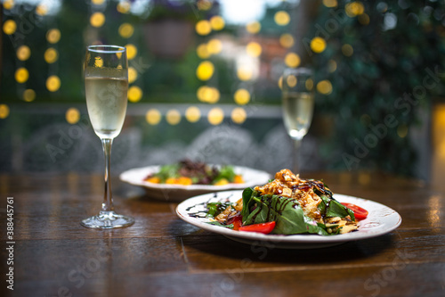 glasses of champagne and salads on bokeh background