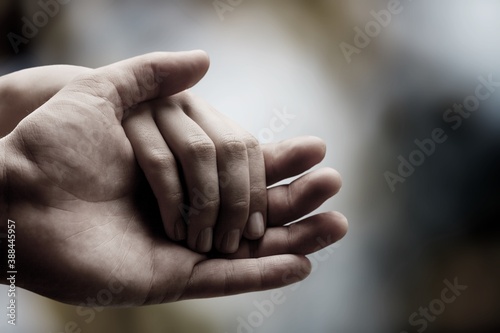 Man and woman hands on bokeh background