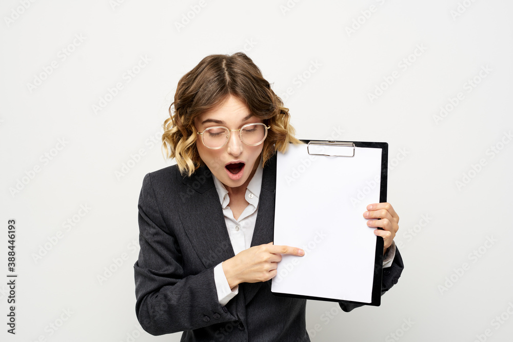 Business woman with a folder of documents on a light background cropped view and shirt suit Business woman with a folder of documents on a light background cropped view and shirt suit