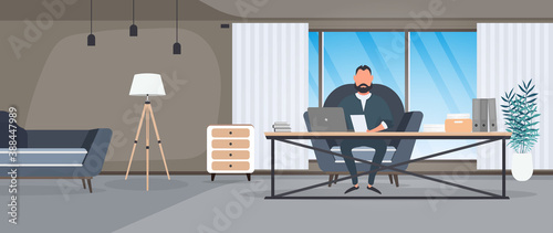 A businessman is working on a laptop in his office. Director's workplace. Laptop, documents, books, loft-style table. Vector.