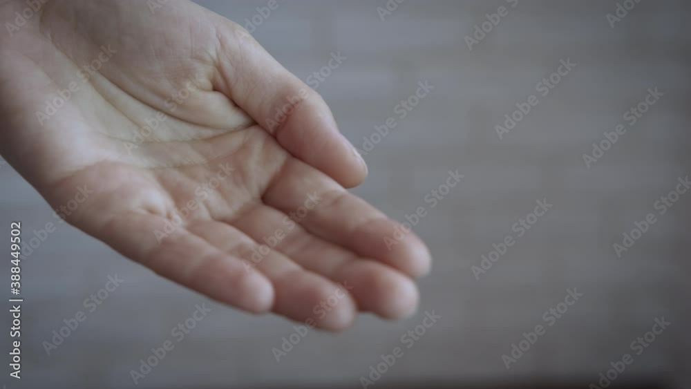 Puts penny in hand. A person give a penny to the woman in the room. Puts penny in hand. A person give a penny to the woman in the room.