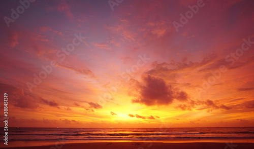 Nature background. Shot of Landscape amazing of red sky sunset in the sea with red clouds background. Travel concept. © BUDDEE