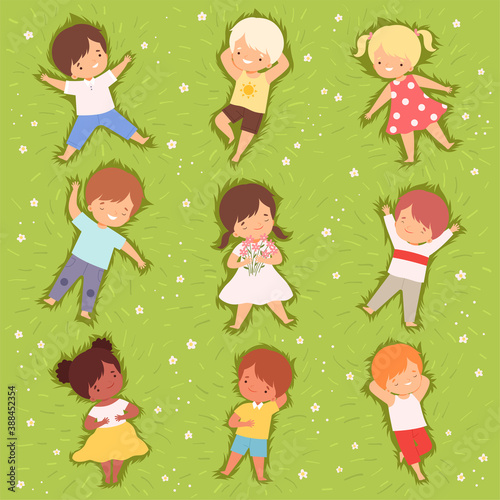Happy Kids Lying Down on Green Lawn Set  Cute Smiling Children Having Fun Outdoors  View from Above Cartoon Vector Illustration