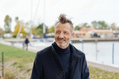 senior man walking outdoors in the wind