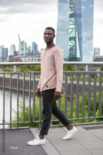 Fashionable Black Man Walking with Head Turned at Camera