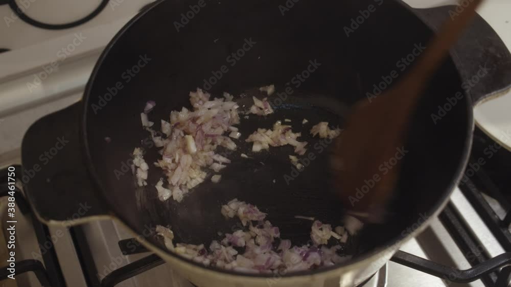 Mixing diced fried onion inside a hot cooking pot during cooking. Kitchen, cooking. Mixing diced fried onion inside a hot cooking pot during cooking. Kitchen, cooking.